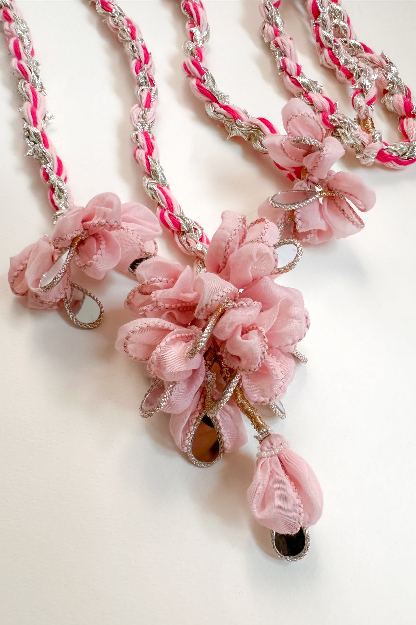 Parandi with pink floral elements on a white background