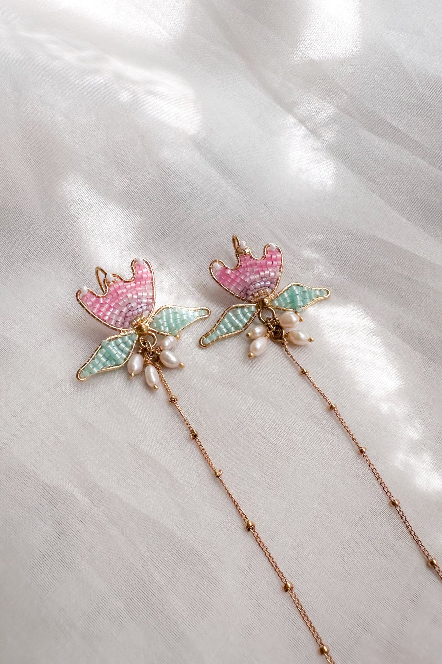 Decorative hairpins with floral designs on a white fabric background