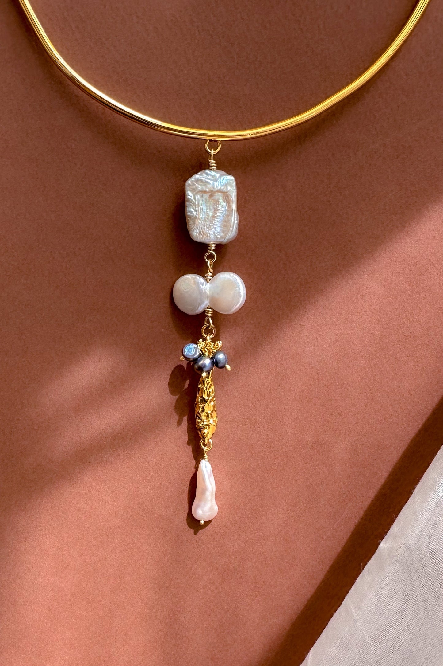 Choker with pearl & Fish Charm displayed on a neutral background