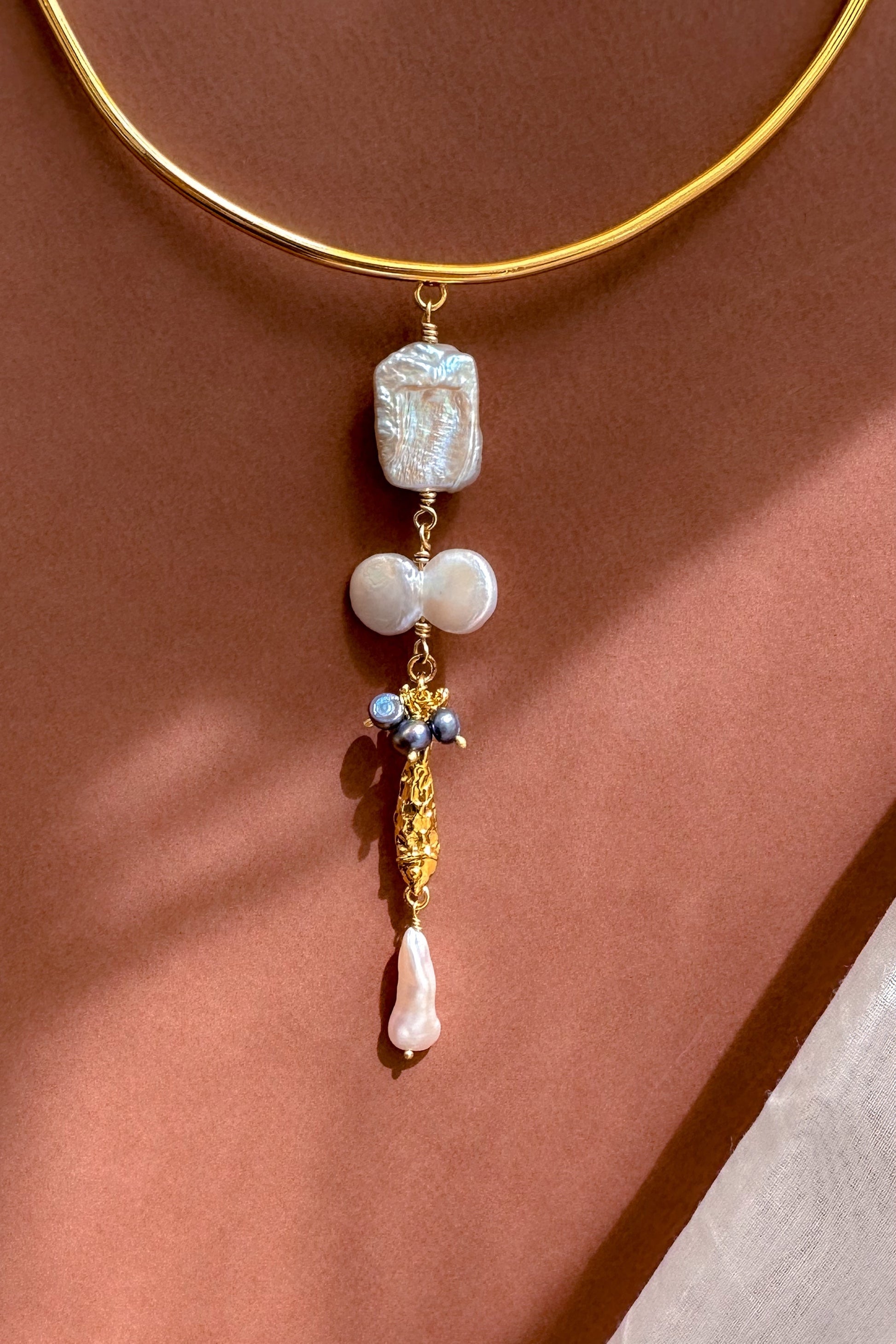 Choker with pearl & Fish Charm displayed on a neutral background