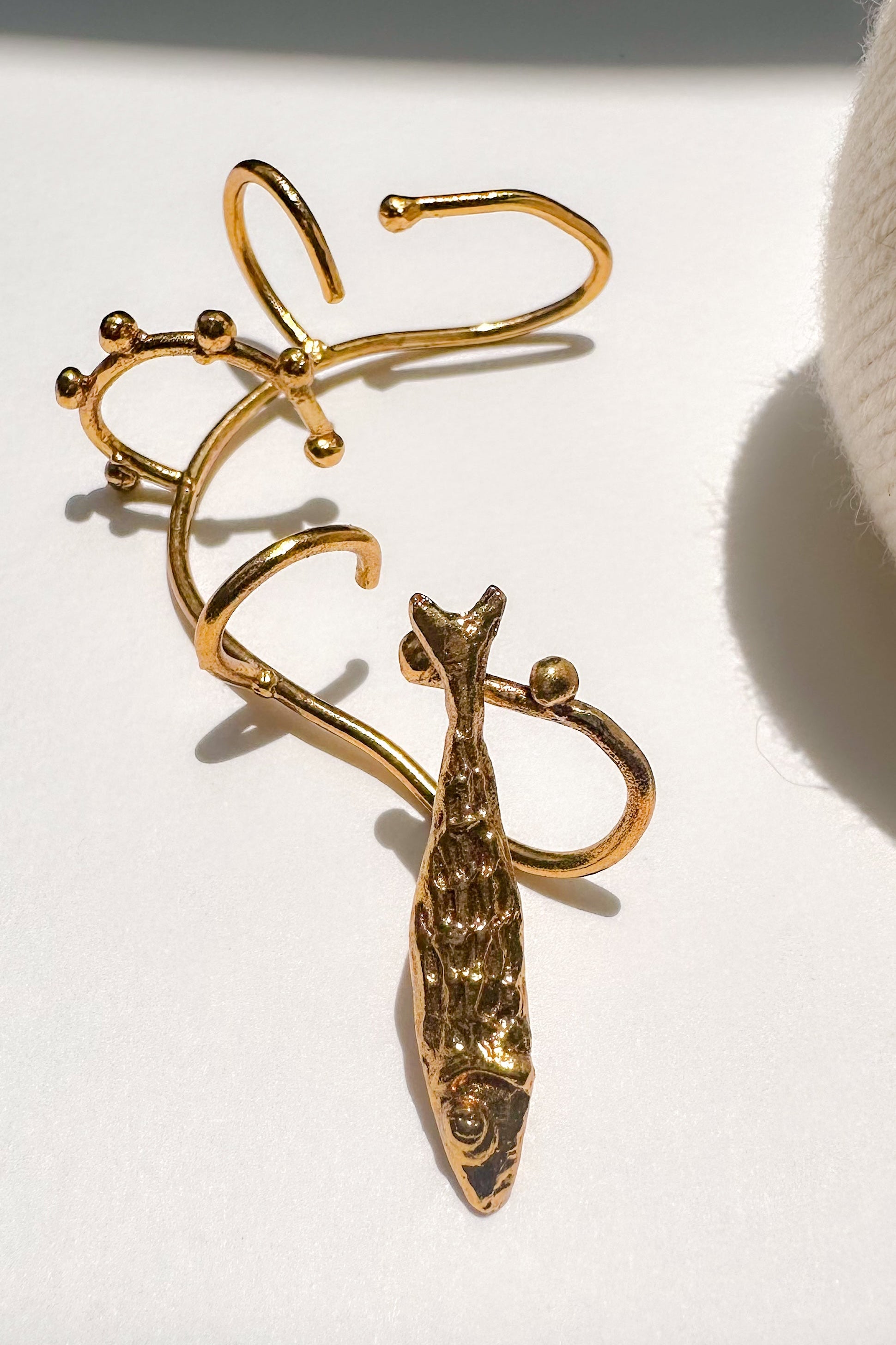 No piercing multi stack earcuff with dangling fish.