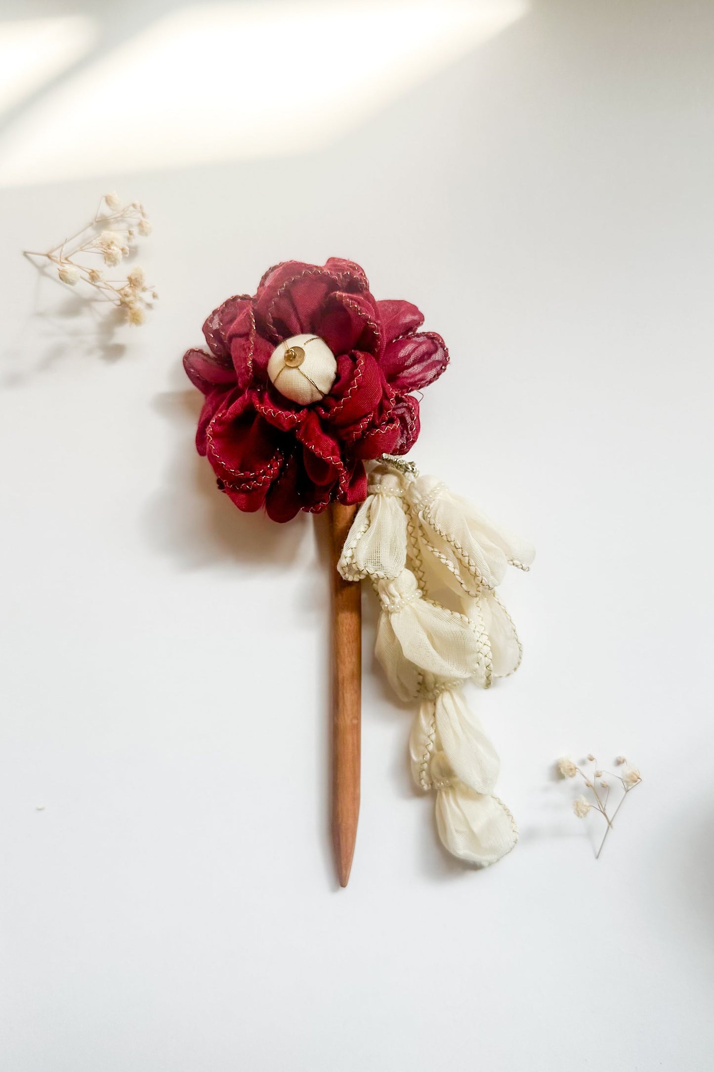 Floral hairpin with red flowers and lace on a white background