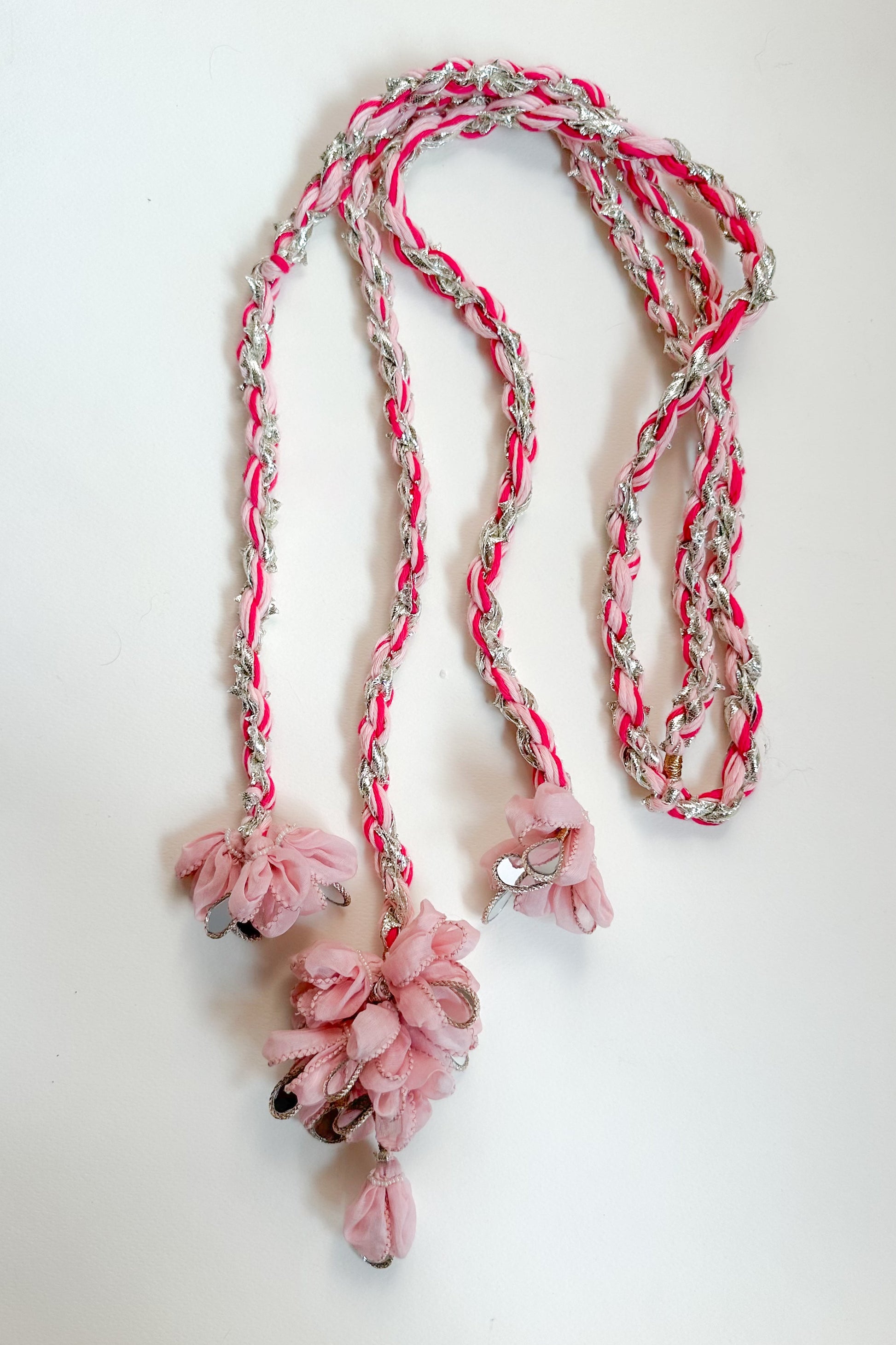 Braided parandi with pink flowers on a white background