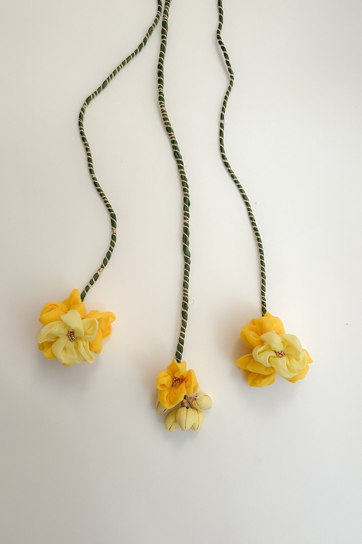 Hair Accessory with yellow flower pendants on a white background