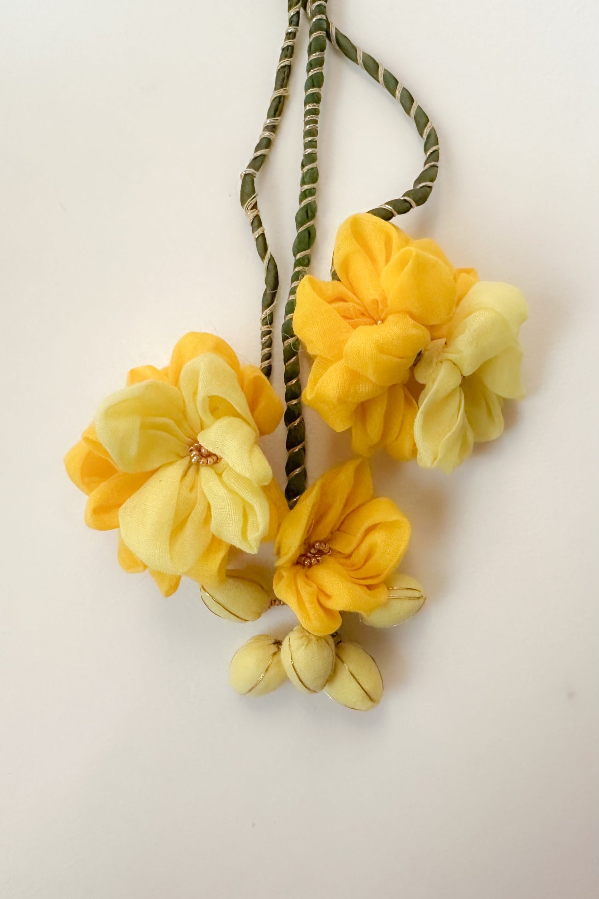 Yellow flower hair tie on a light background