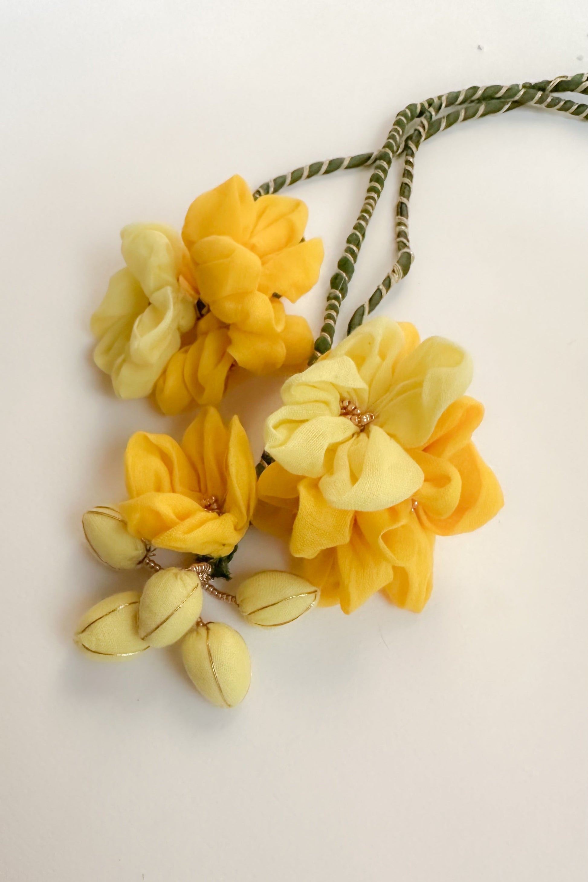Yellow floral hair ties on a light background