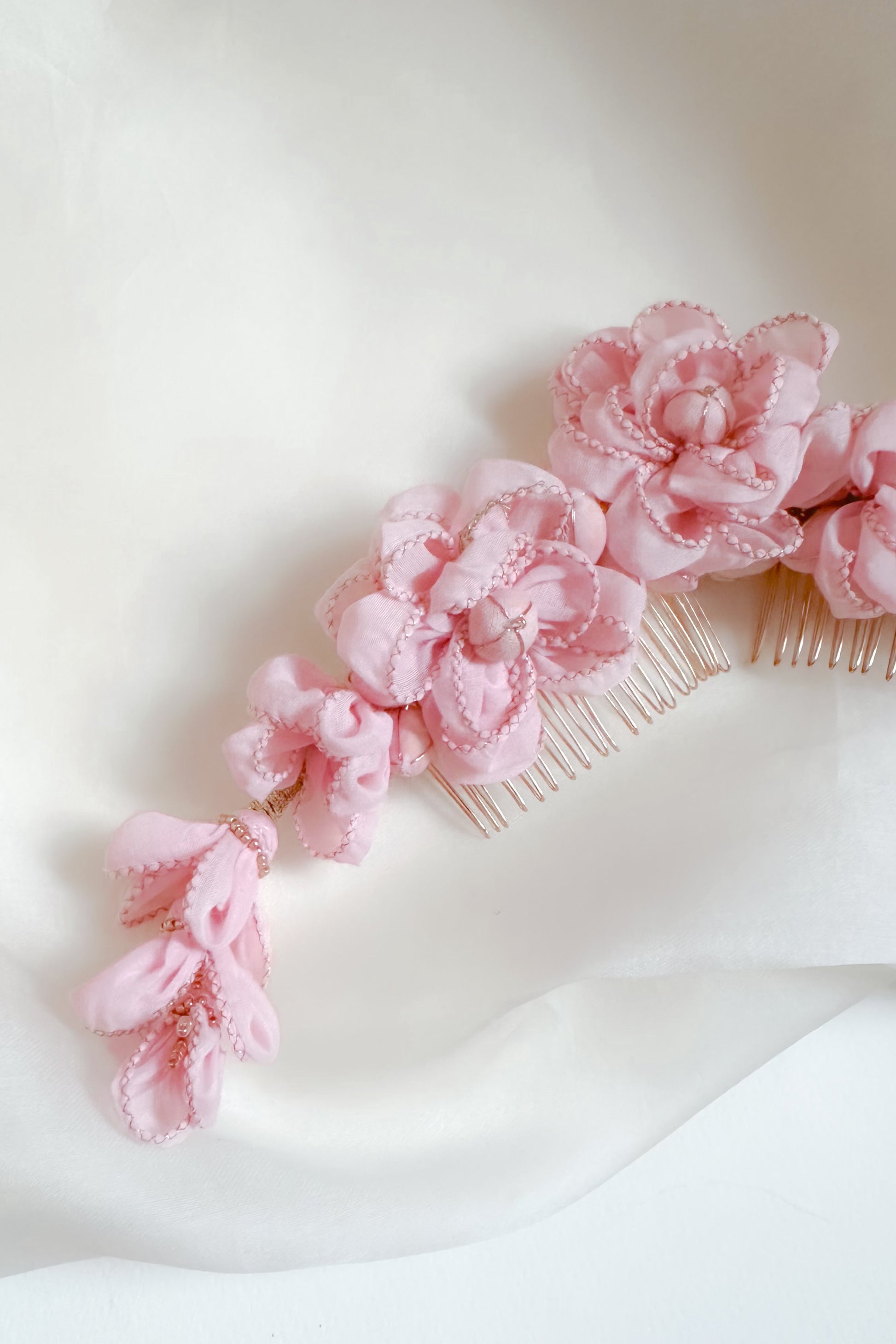 Pink floral hair comb on a white background