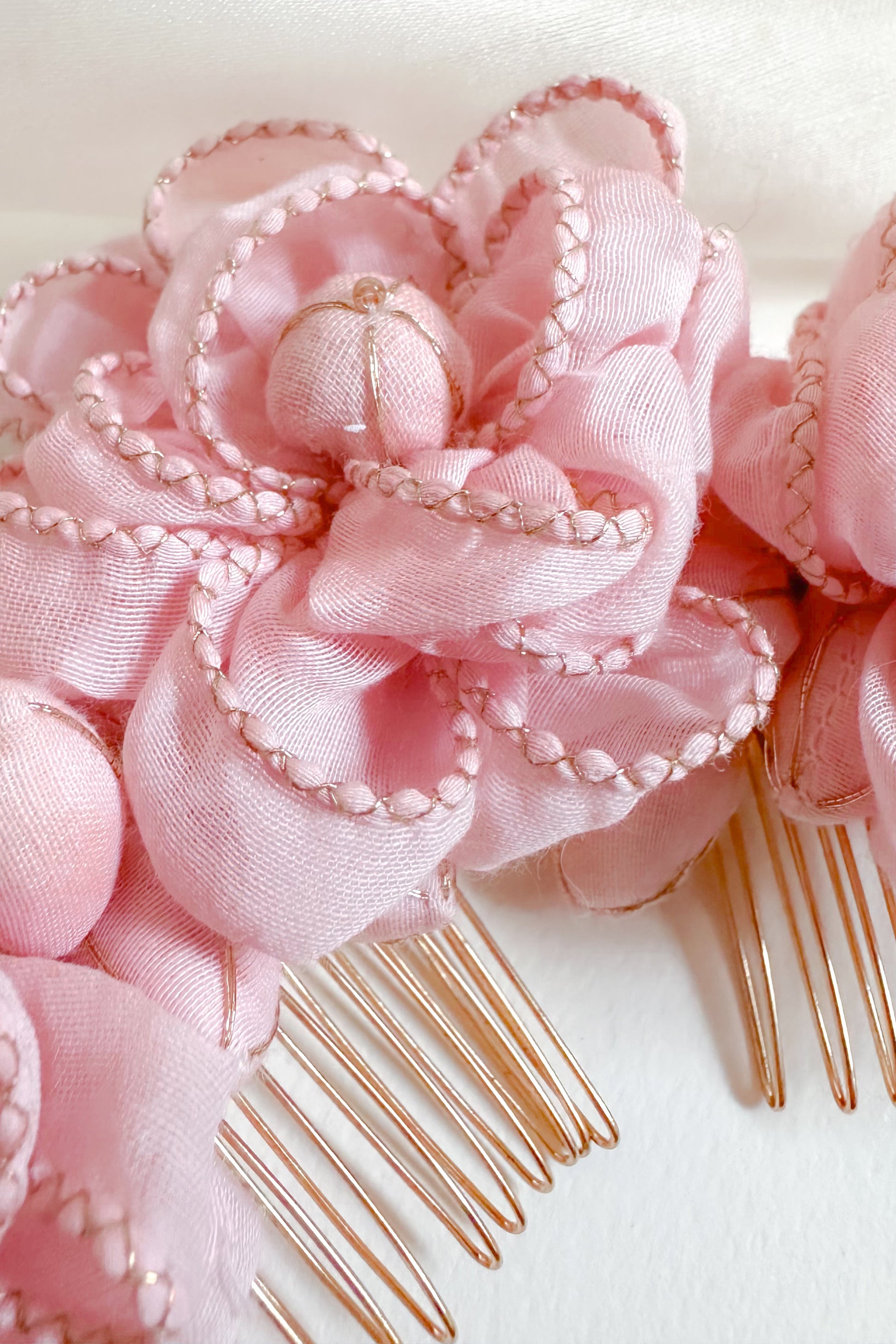 Pink floral hair comb on a white background