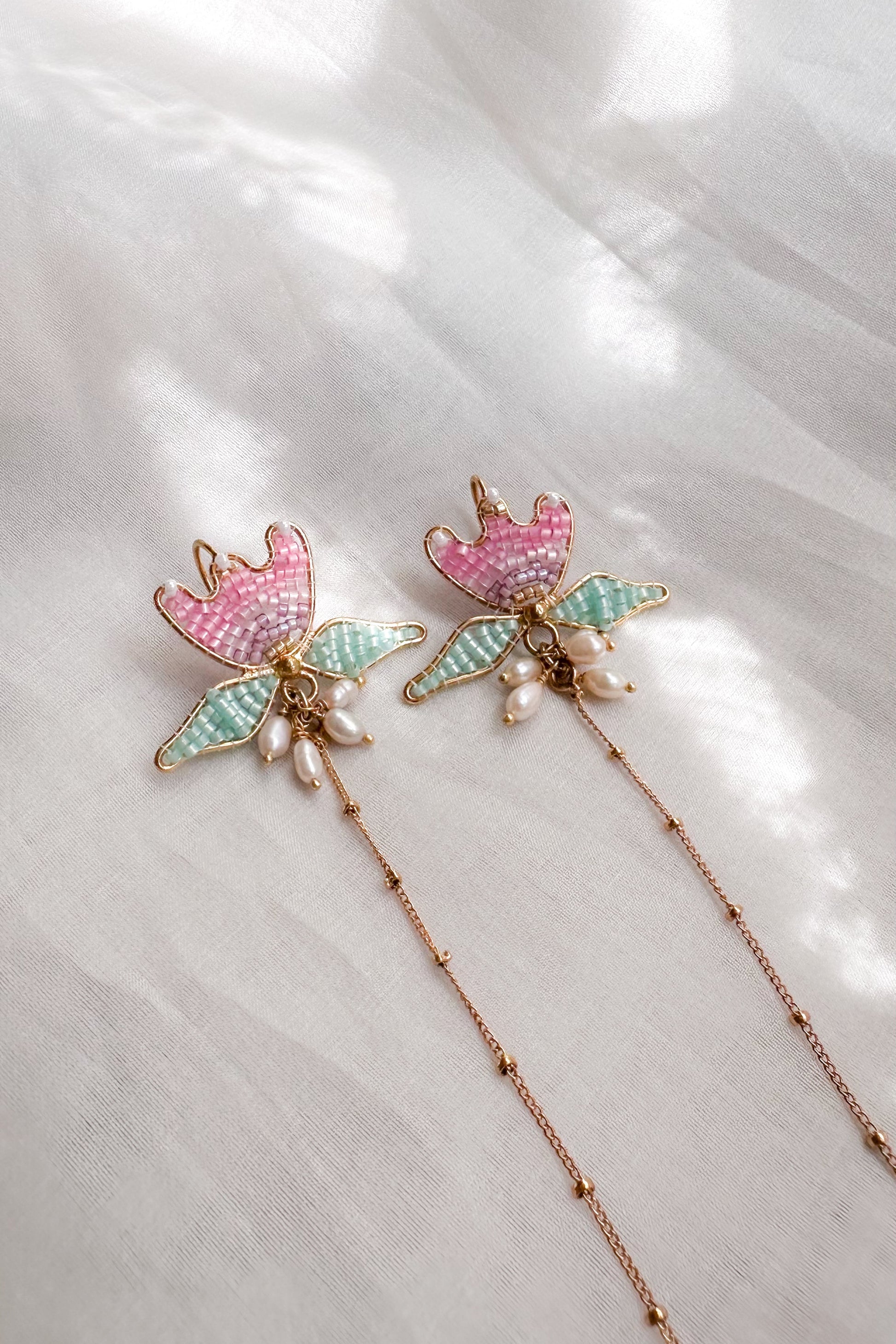 Decorative hairpins with floral designs on a white fabric background