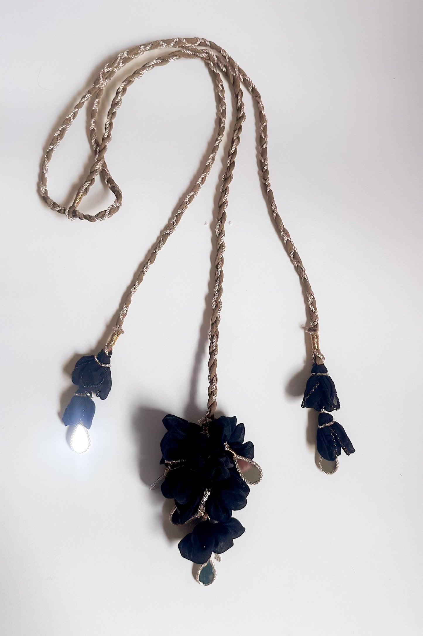 Parandi with black floral pendants & dangling mirror hangings on a white background