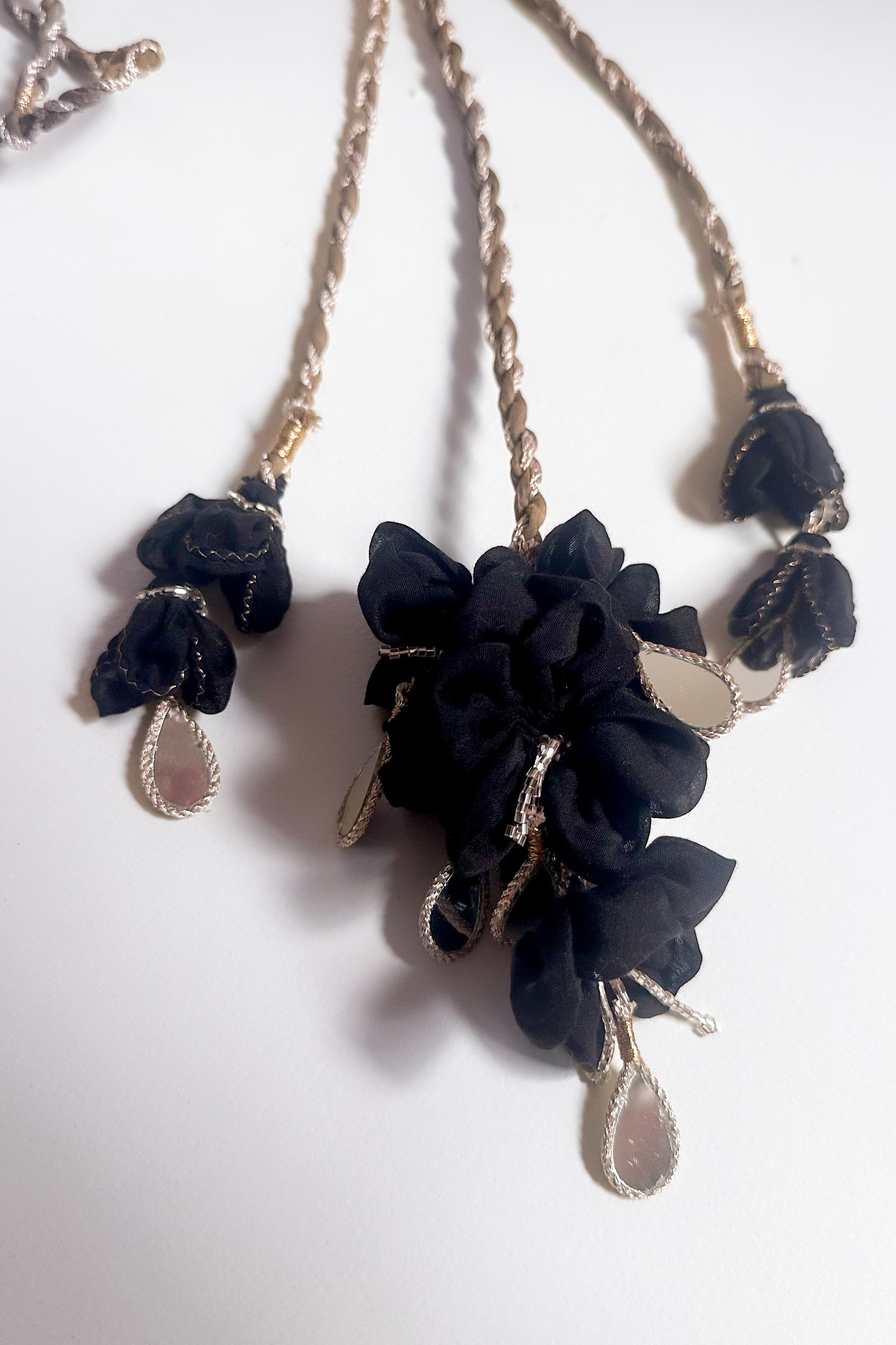 Parandi with black floral pendants & dangling mirror hangings on a white background