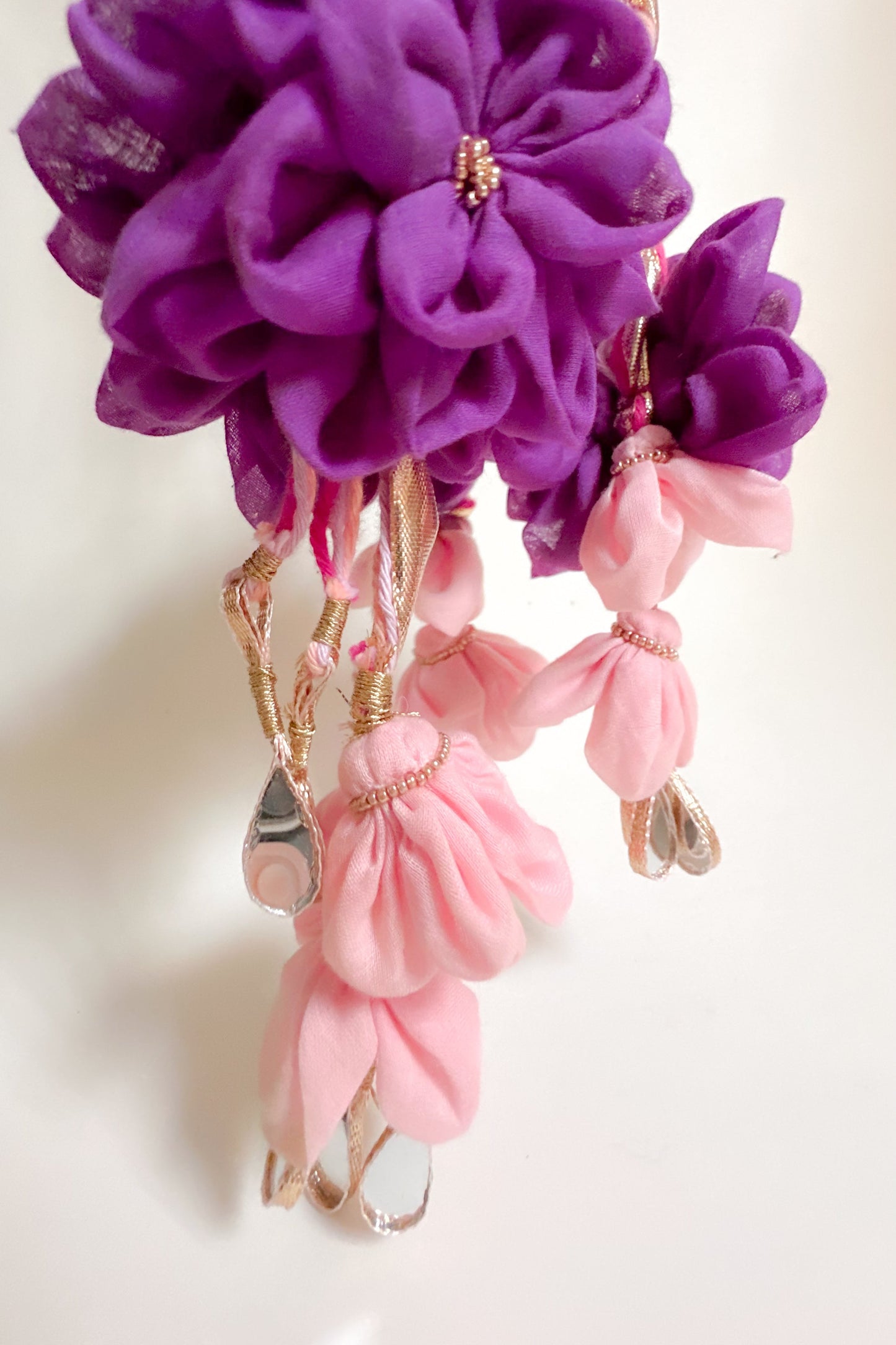 Decorative Parandi with purple and pink flowers on a white background. Haldi Parandi for Brides
Yellow Haldi Floral Parandi
Handmade Bridal Parandi India
Haldi Ceremony Hair Accessory
Mehendi Ceremony Hair Accessories
Indian Wedding Braid Accessories
Floral Braid Parandi for Brides
Cotton Mull Flower Parandi
Mirror Work Parandi Online
Gota Braid Hair Accessory
Traditional Indian Hair Ornaments
Haldi Function Accessories for Bride
Wedding Hair Accessories India
Ethnic Hair Accessories Online
Bridesmaid Hair 