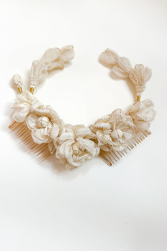 Decorative headband with floral designs on a white background