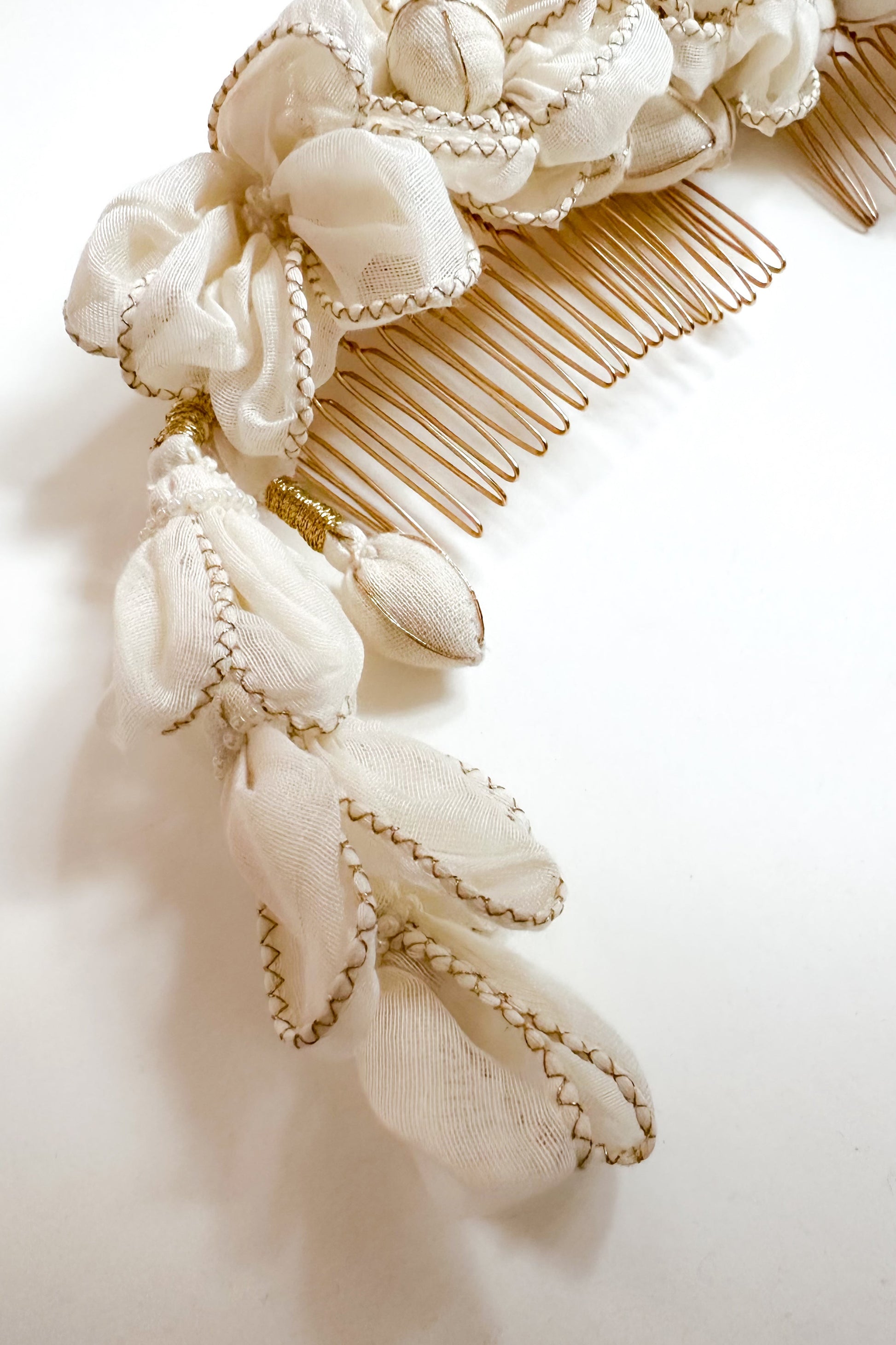 Decorative hair comb with floral and lace details on a white background
