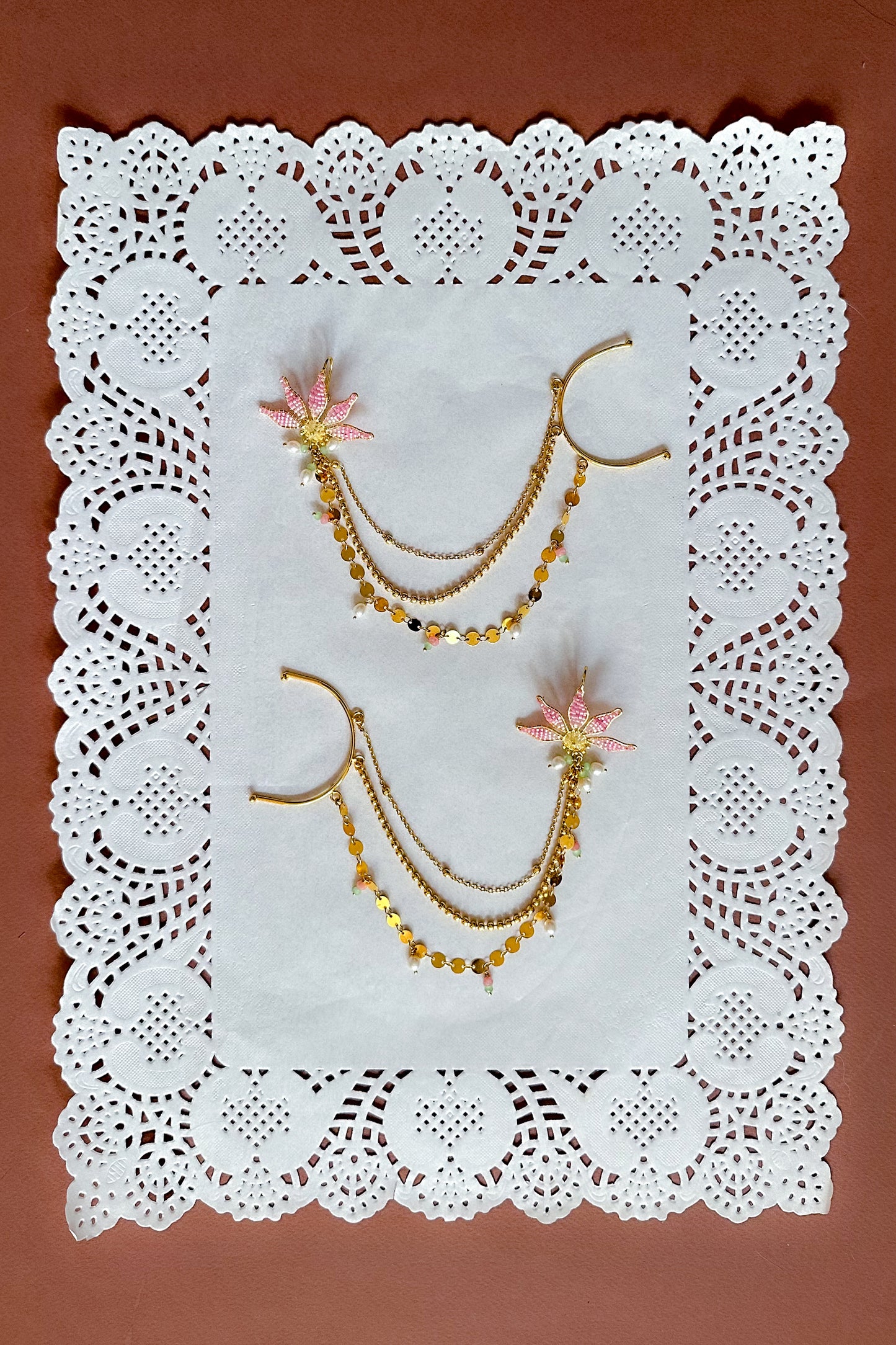 Floral  pendant Sahara on a white doily against a brown background